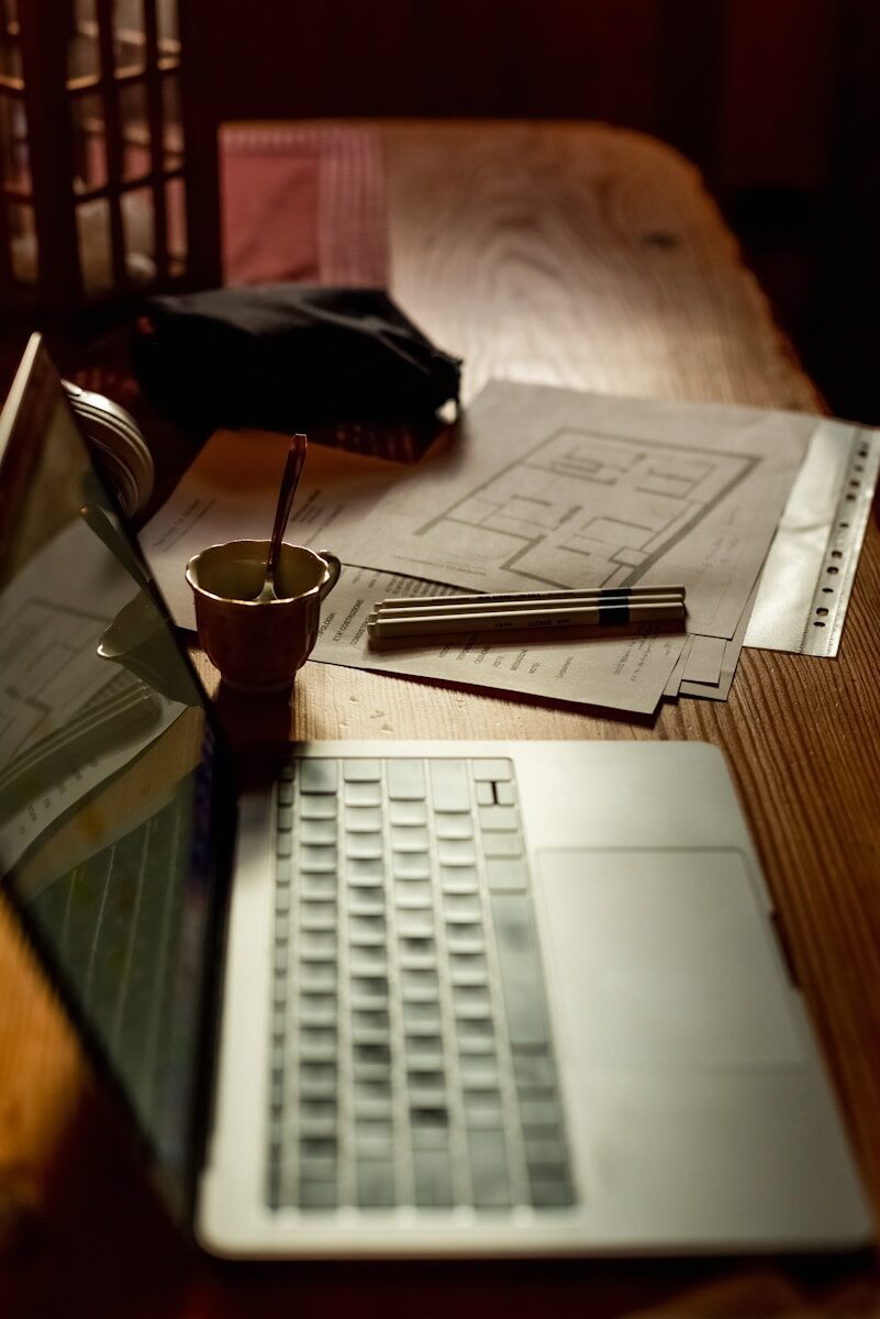 a laptop computer sitting on top of a wooden table
